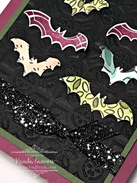 Detail of paper bats and glitter ribbon on card by Paula Cannon.